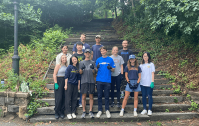 Photo of group of volunteers stood on steps in New York park smiling.